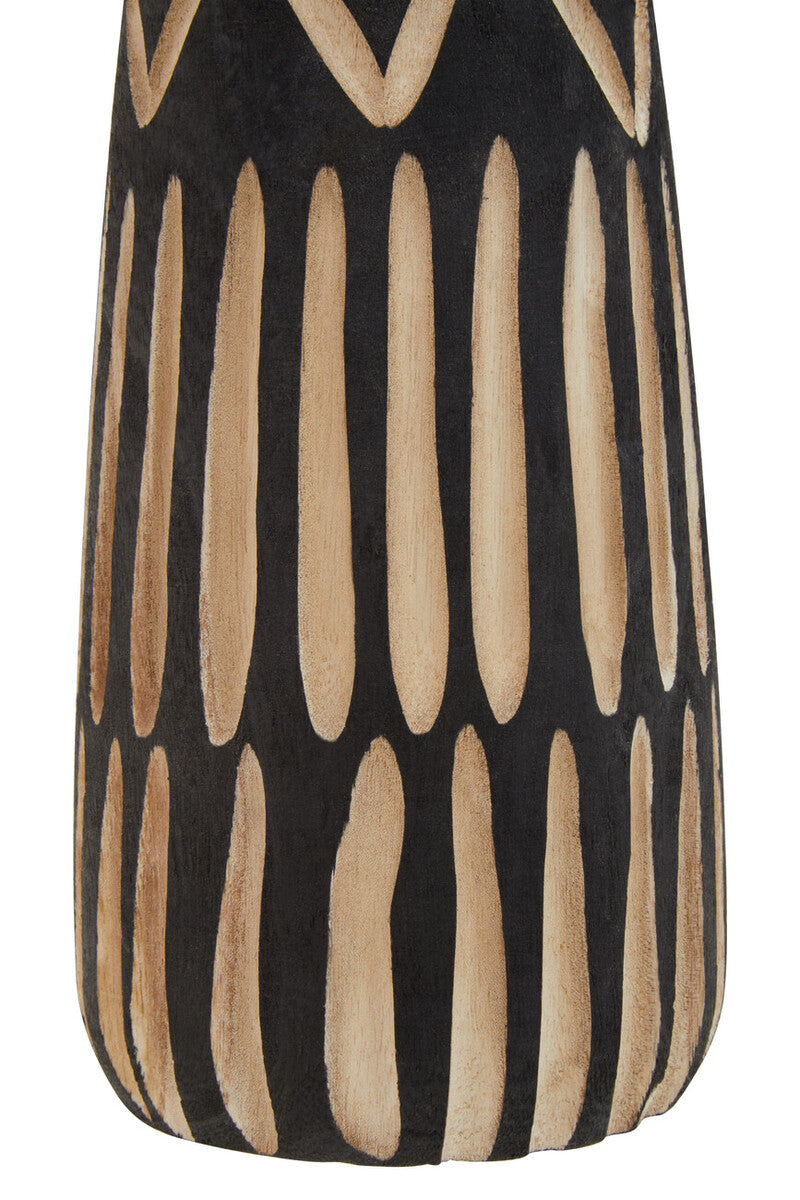 Close up photo of natural carved details on a black wooden vase