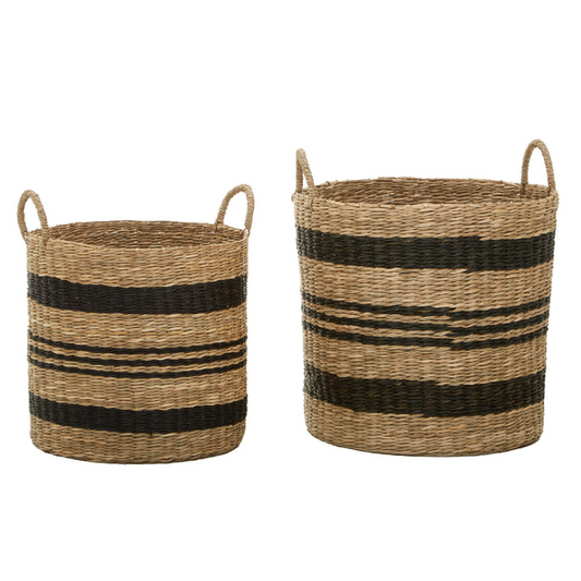 Two natural seagrass baskets with black stripes around them, sitting side by side on a plain white background